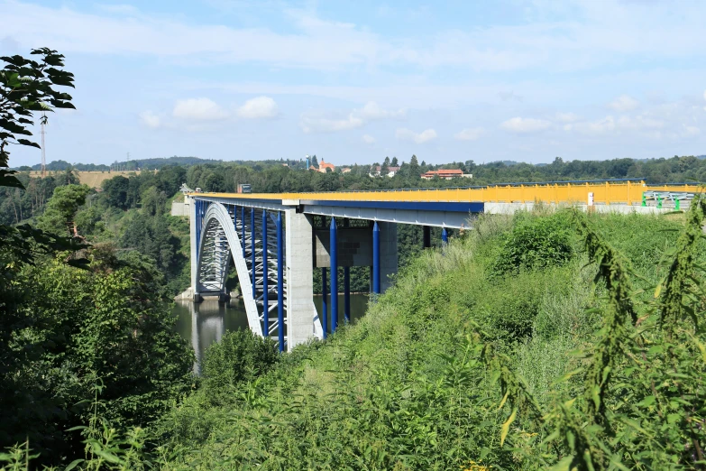 a train riding over the bridge over the water