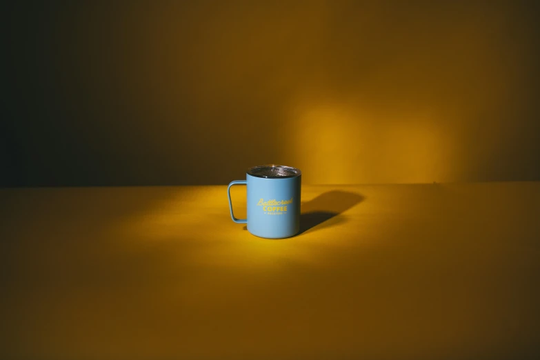 there is a blue cup sitting on the table
