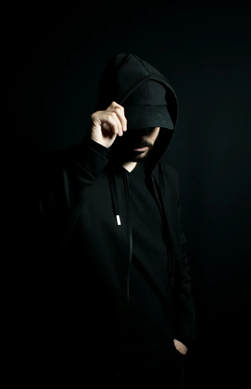 man in black hoodie looking into camera