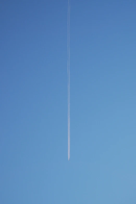 an airplane has long lines across its body as it flies overhead