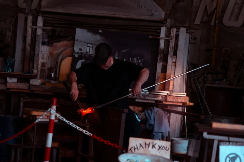 a man is holding a piece of wire inside