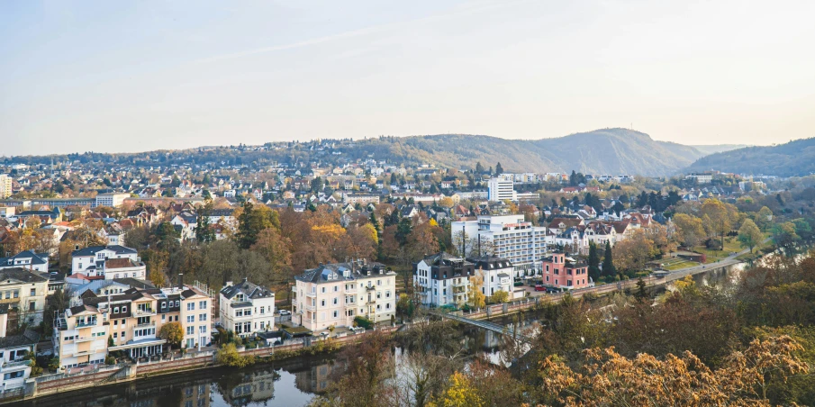 buildings along the water line with mountains in the distance