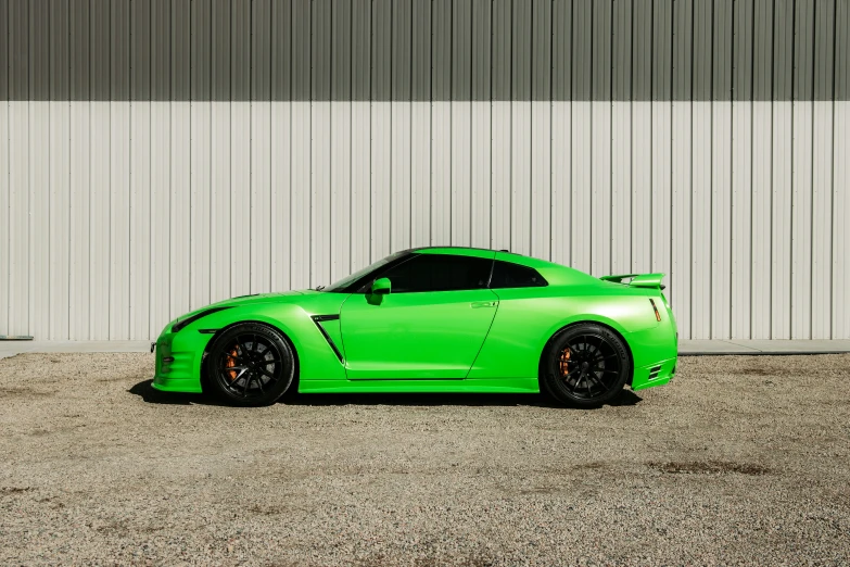 a bright green car parked in front of a wall