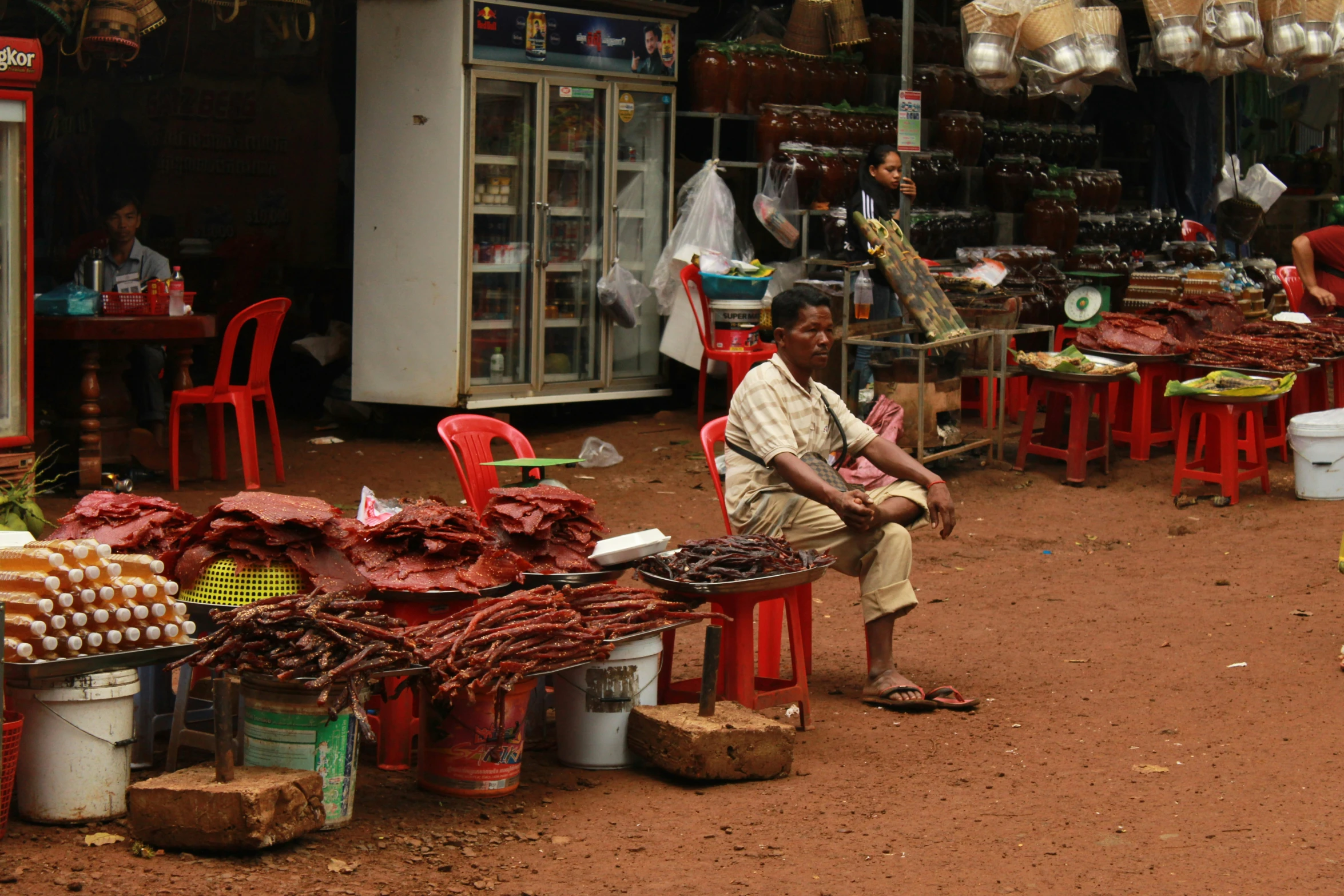 an old man sitting on a bench in a store