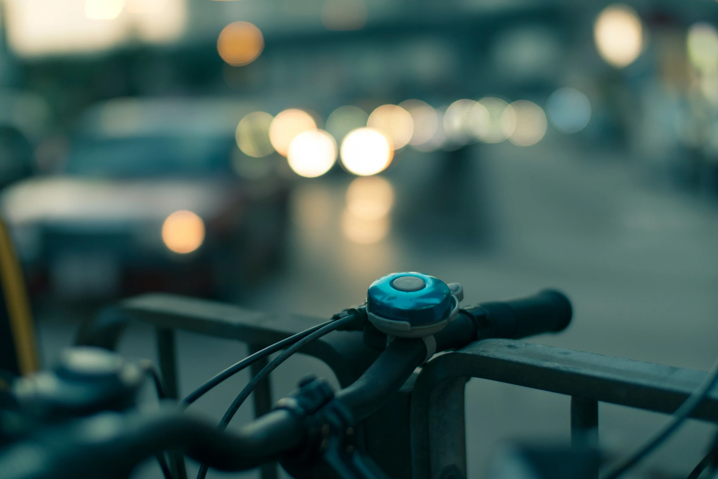 a bicycle handlebars and a blue  on a street