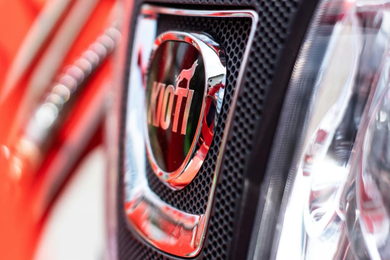 the badge on the front of a red car