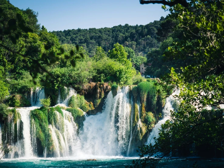 a body of water with a waterfall in the distance