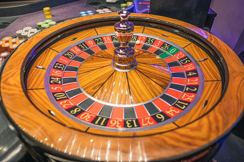 a game of roulepot surrounded by casino chips
