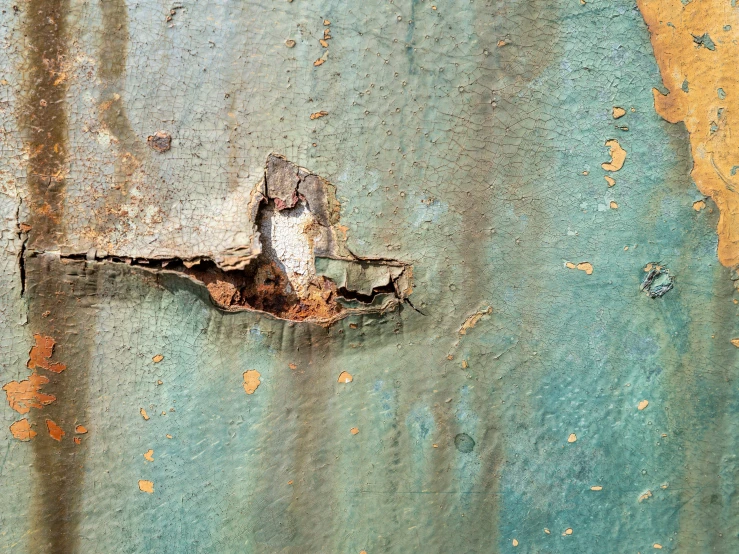 an old peeling metal surface with peeling paint