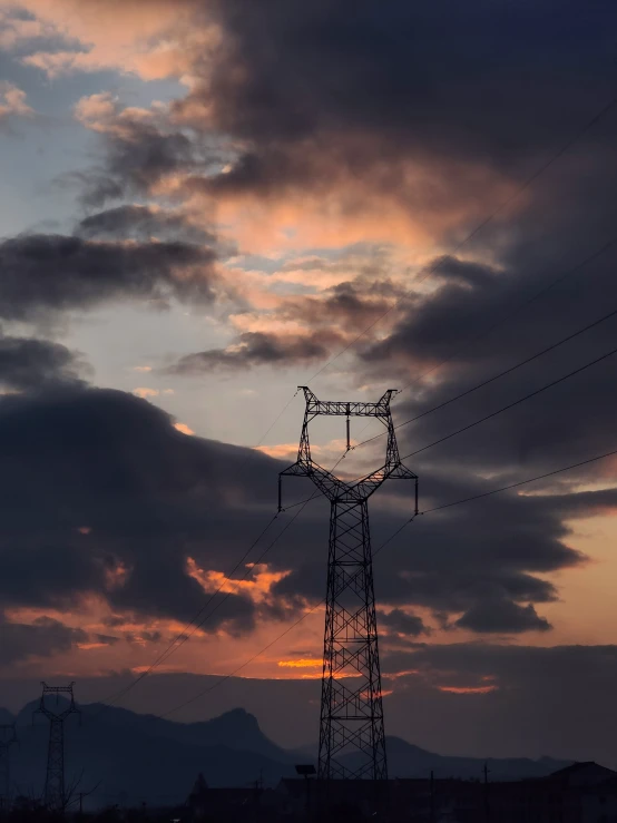 a telephone pole on a cloudy sky