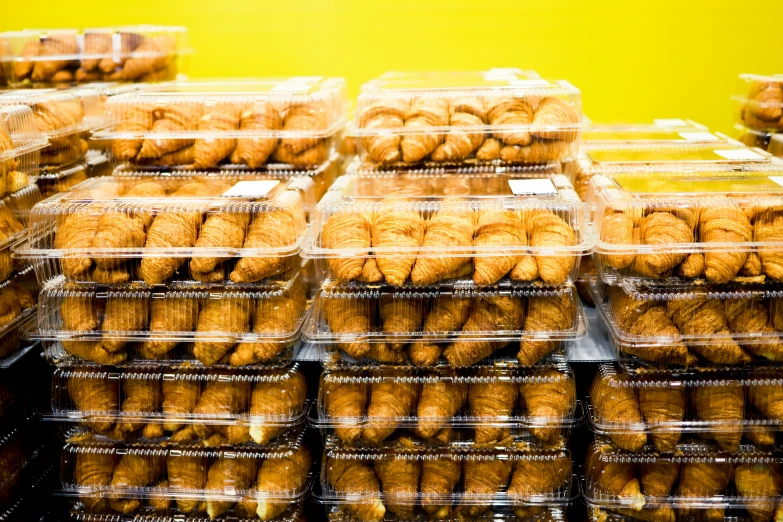 a pile of trays of different kinds of donuts