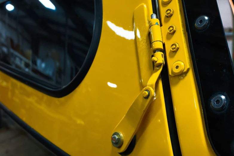 the front of a car with yellow and black trim