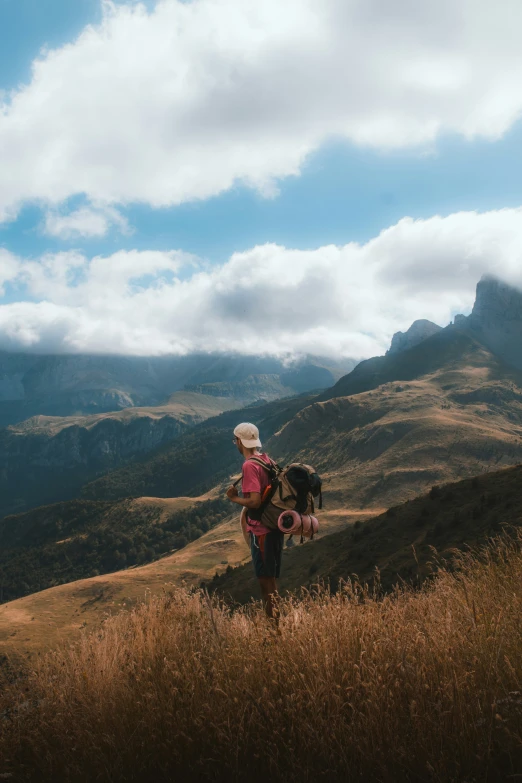 a man on the side of a hill with a dog in his lap