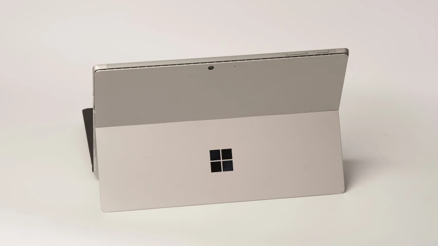 a white and grey laptop computer sitting on top of a table