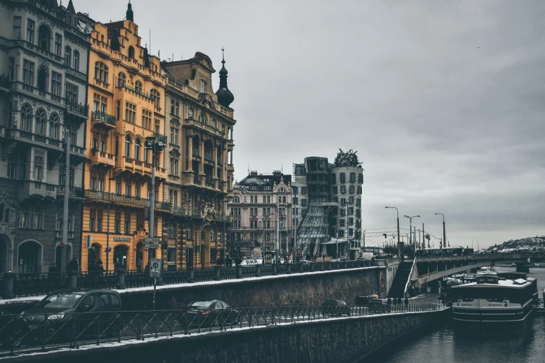 the boats are in the canal by the buildings