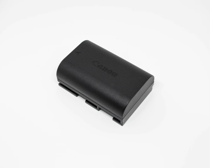 a black battery case sits on a white surface