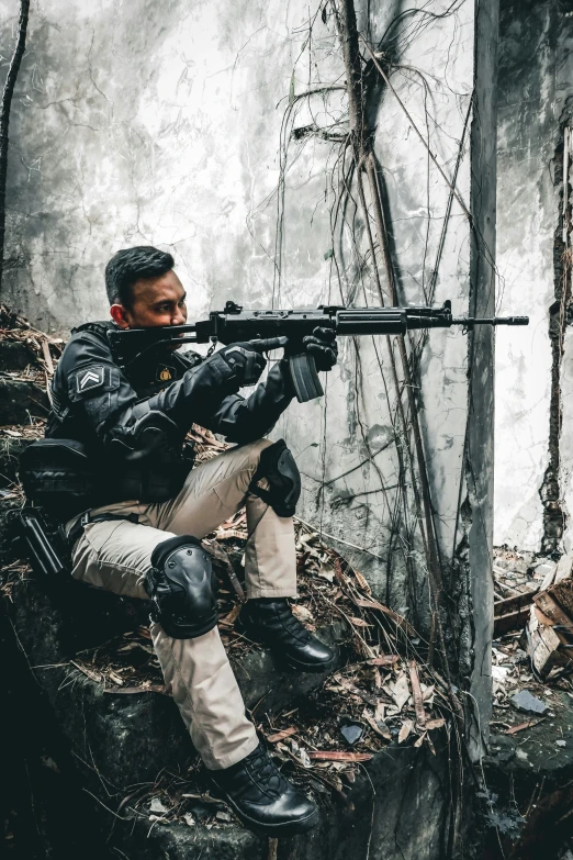 man in a black jacket aiming a rifle