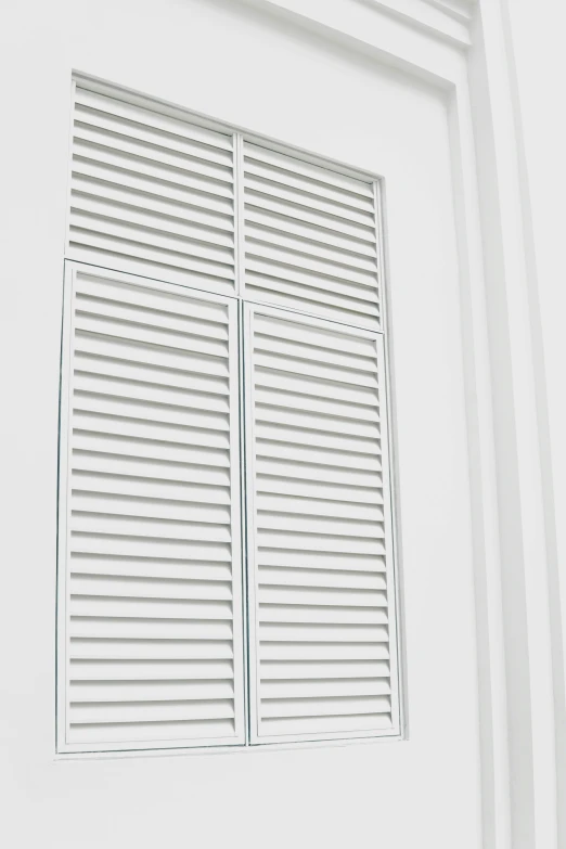 a close up of a white wall and window