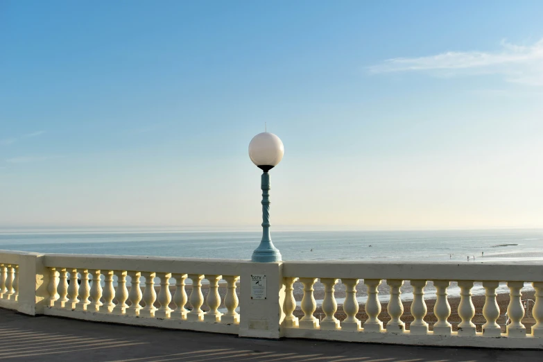 a street lamp sitting on the side of a railing