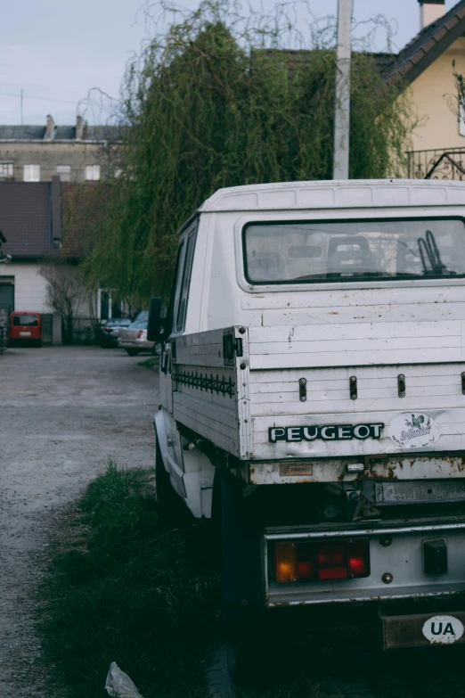 a white truck with a graffiti written on the back