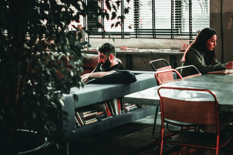 two people sit at a table eating food