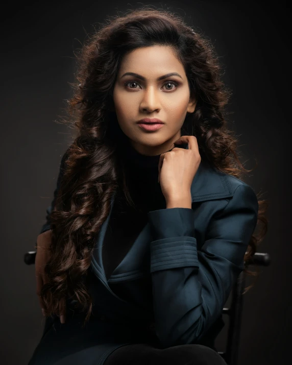 an indian woman in a chair posing for the camera