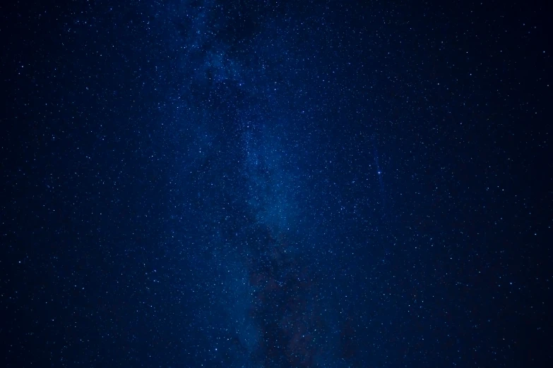 a po taken from the ground of the night sky with stars