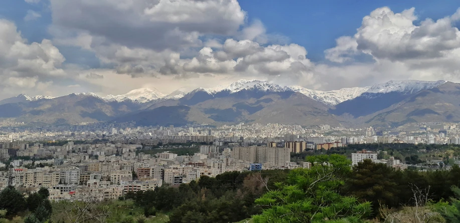 a large city with mountain range in the background