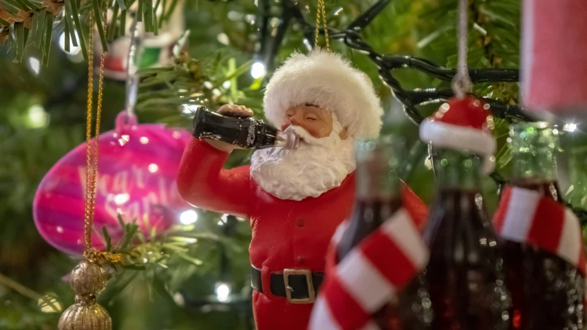 a man that is standing up near a christmas tree