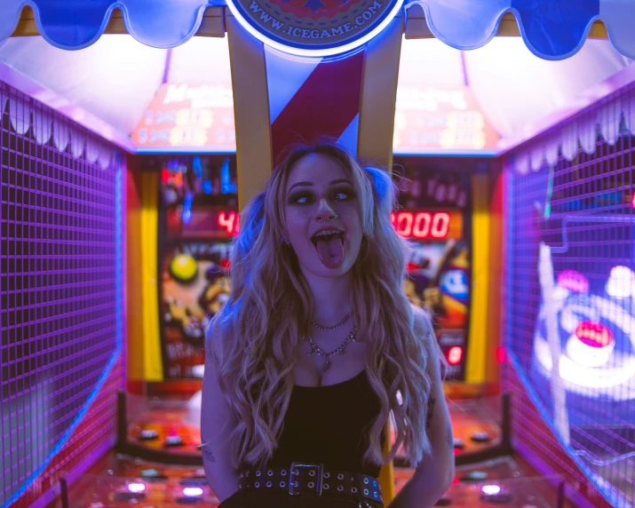 a young lady is standing in a video game room