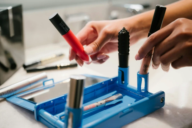 two people using small tools on some kind of device