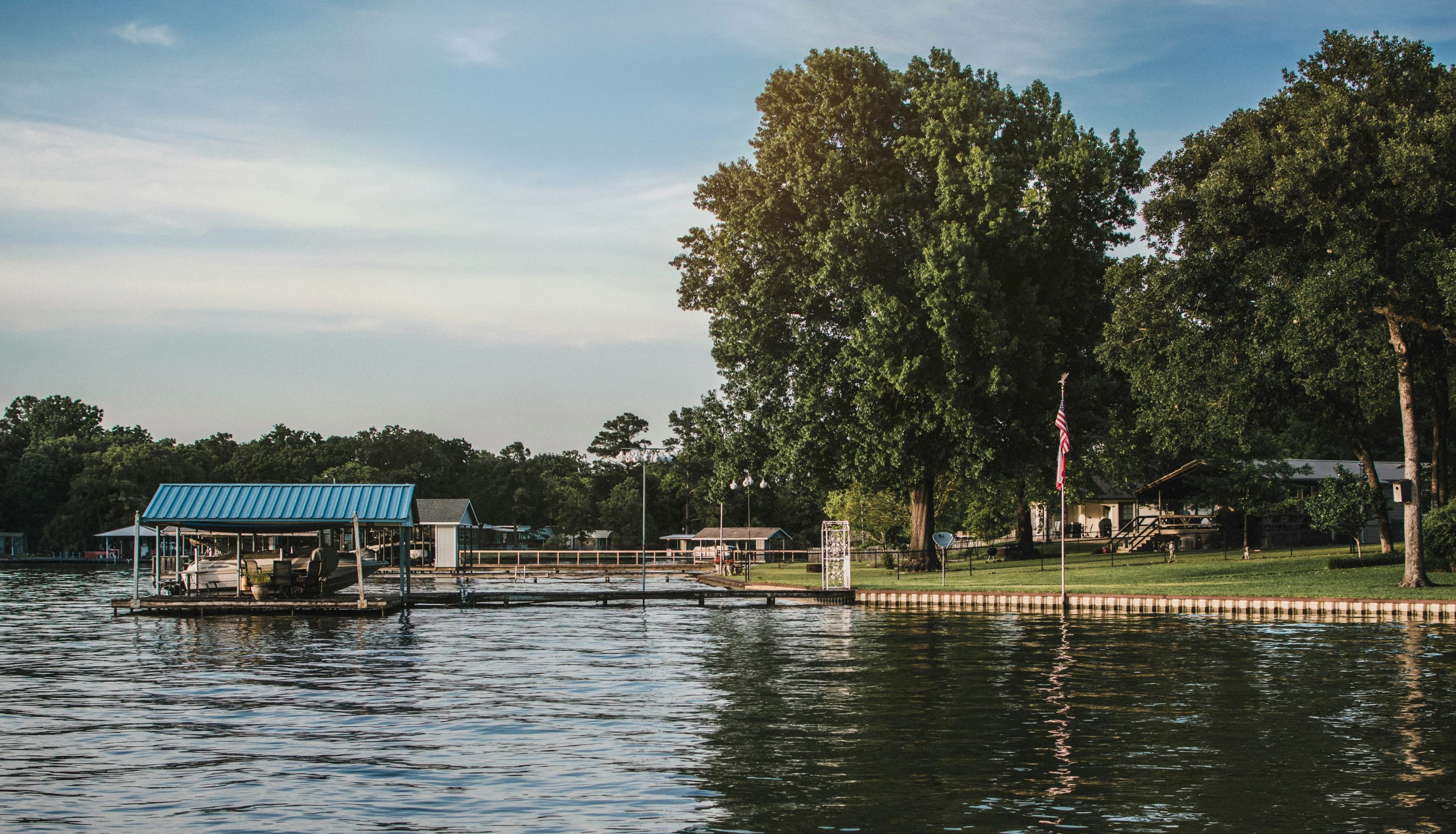 a large body of water surrounded by green trees