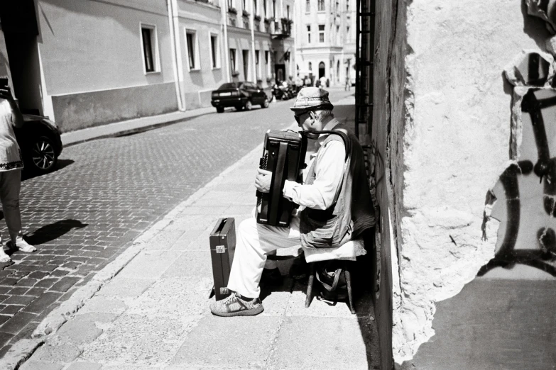 a person sitting on a bench next to a wall