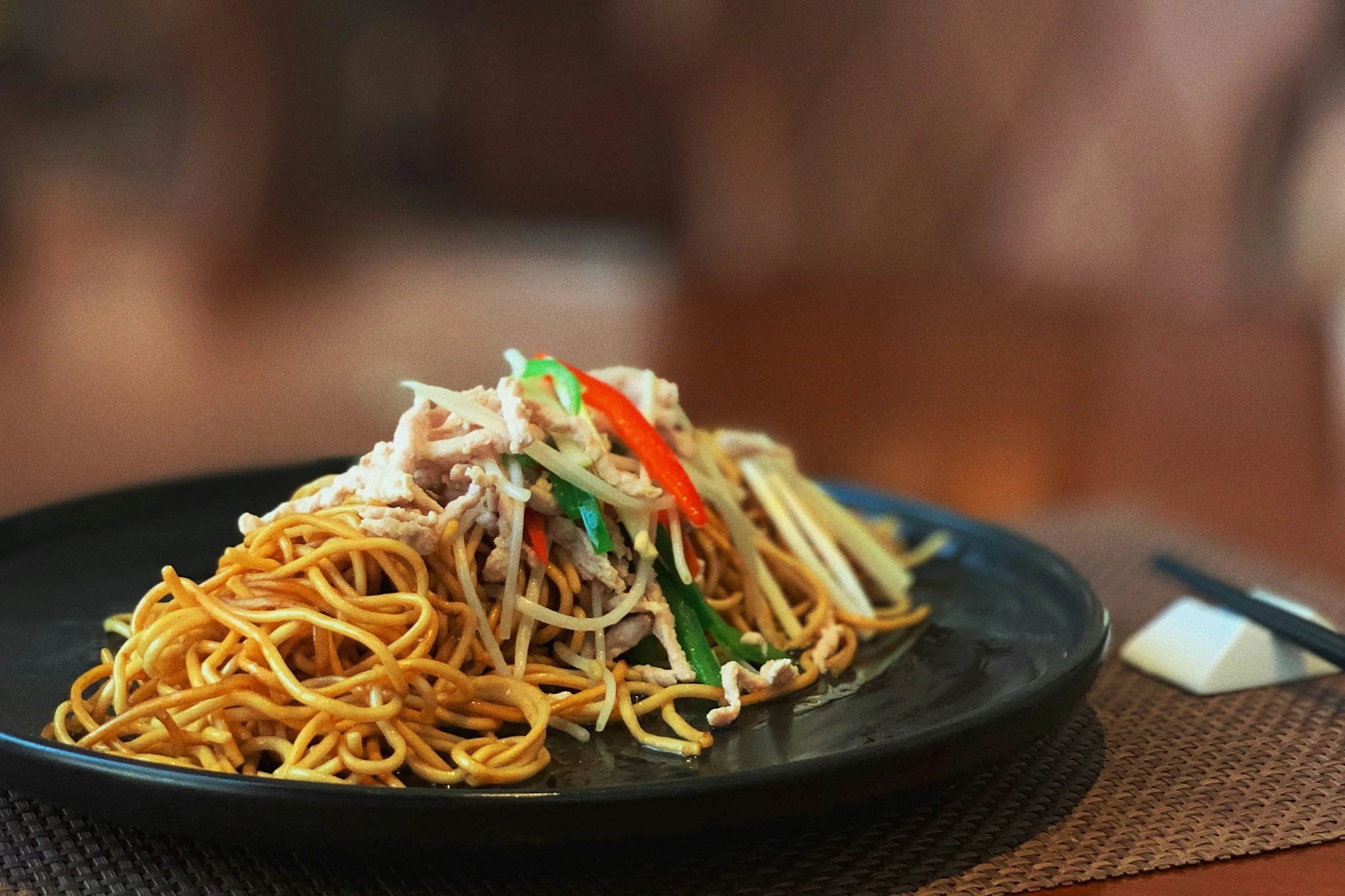 a plate filled with noodles on a table