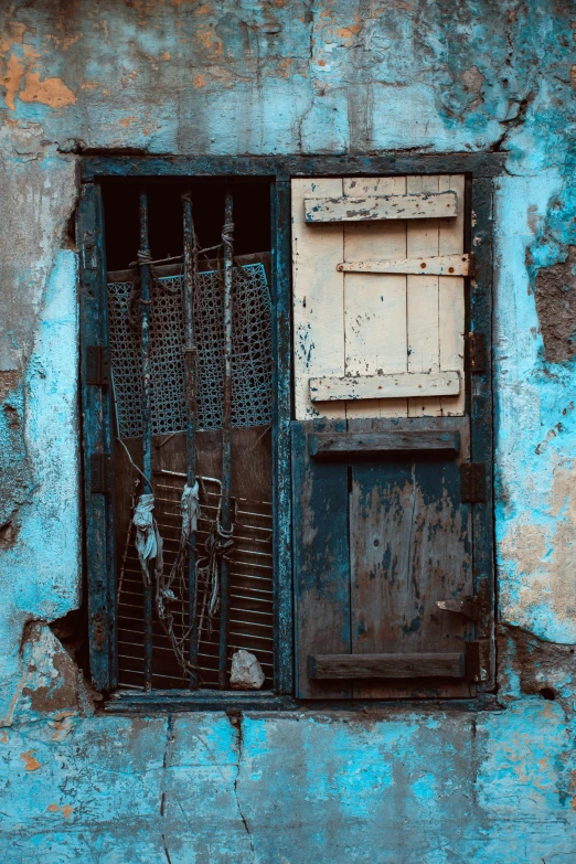 a window with bars and bars in it in an old building