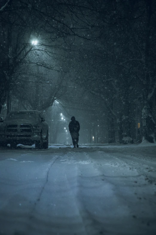 a person walking alone on a street at night