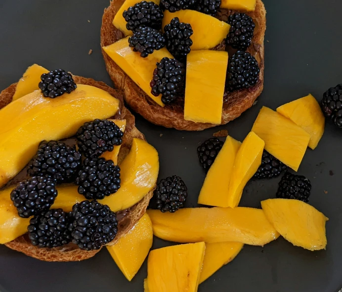 fruit on toast with blackberries, mangos, and strawberries