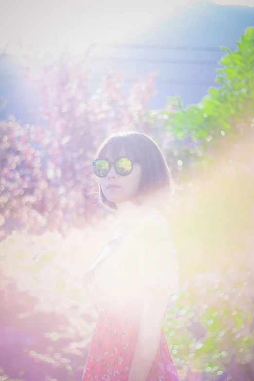 woman in a dress with sunglasses on looking up