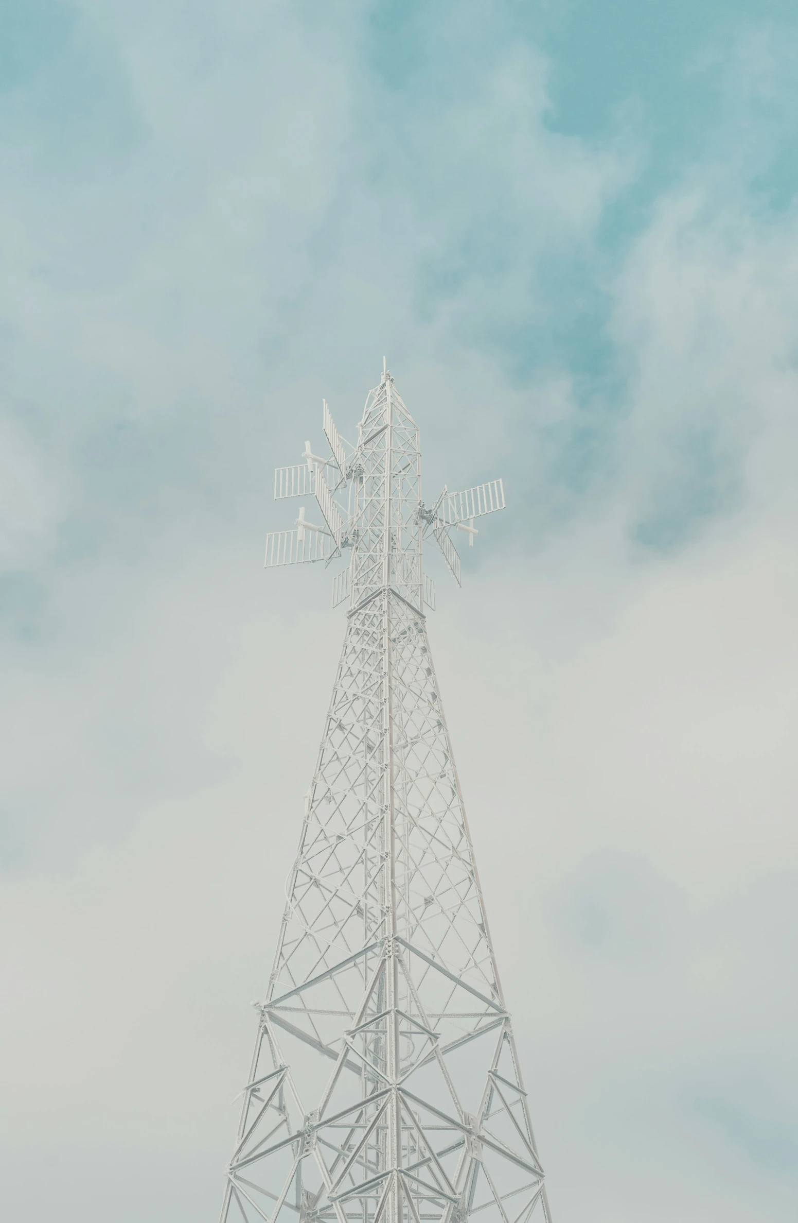 a tall electrical tower with some wire above it