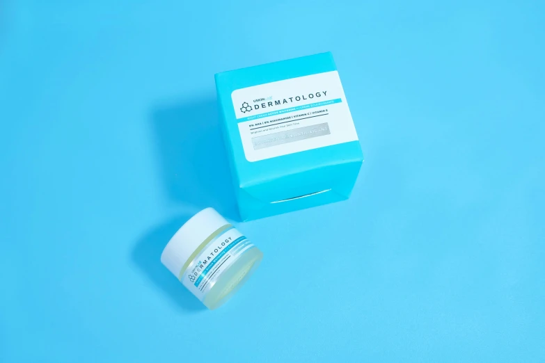 a white container with a blue top sitting on top of a blue surface