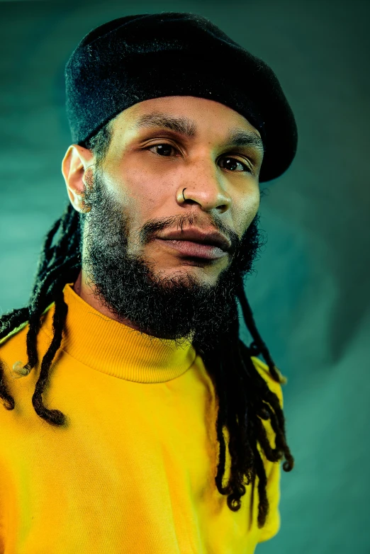 a bearded man wearing a yellow shirt and hat