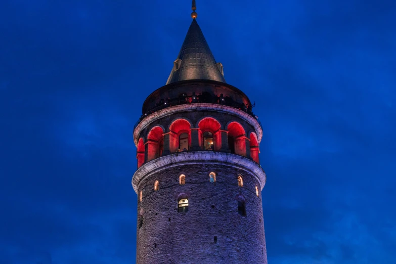 a tower with a clock and lights on top of it