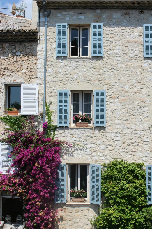 a large building with several windows covered in white shutters