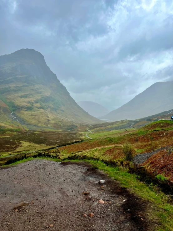 the road is narrow and empty in this mountain valley