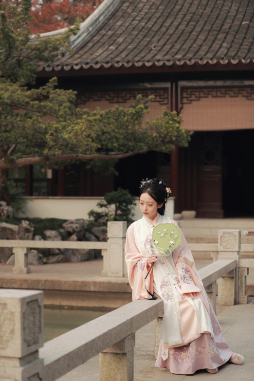 the asian woman in the traditional dress is looking