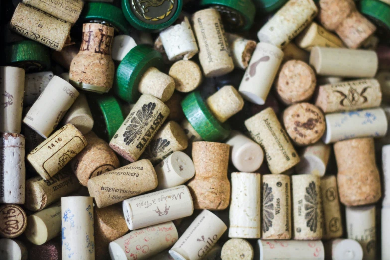 a collection of wine corks are lying side by side