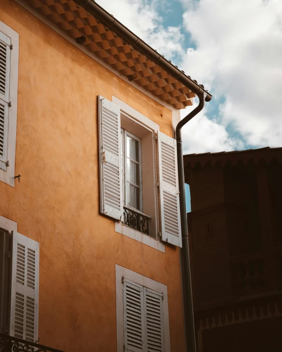 a building with white windows and white shutters