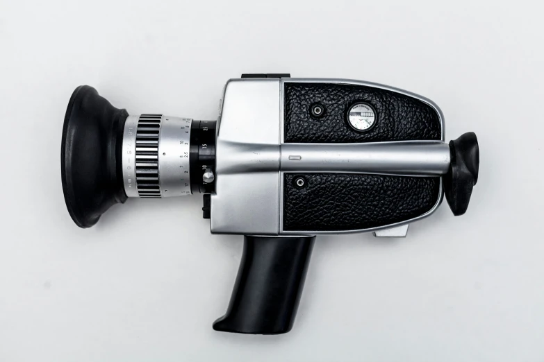 a black camera on the wall with a silver lens