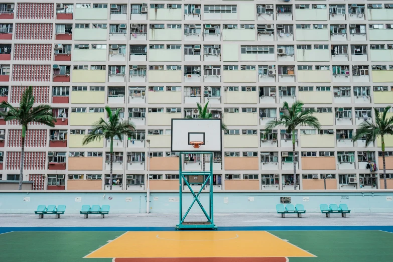 a basketball court with a basketball in front of buildings