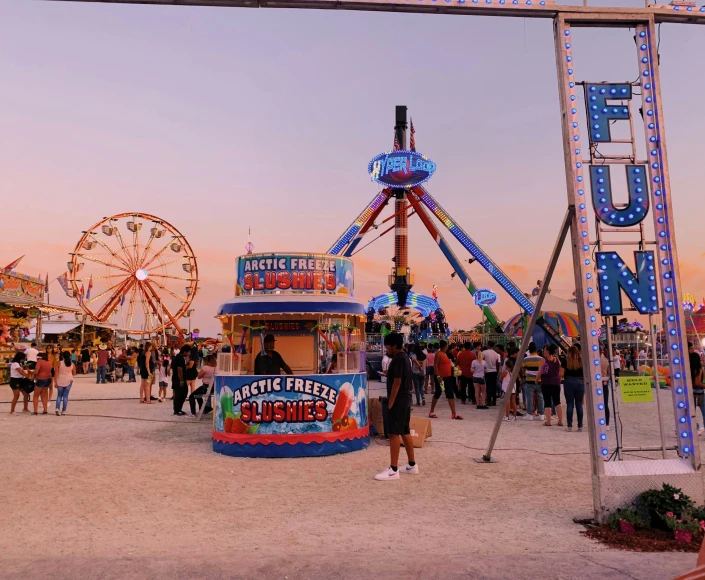 a man standing in front of a carnival rides and merry go round